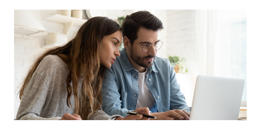 Couple using laptop at home