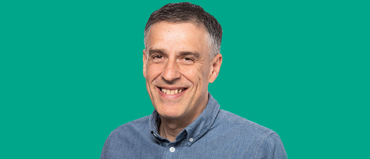 Man leans against blue car