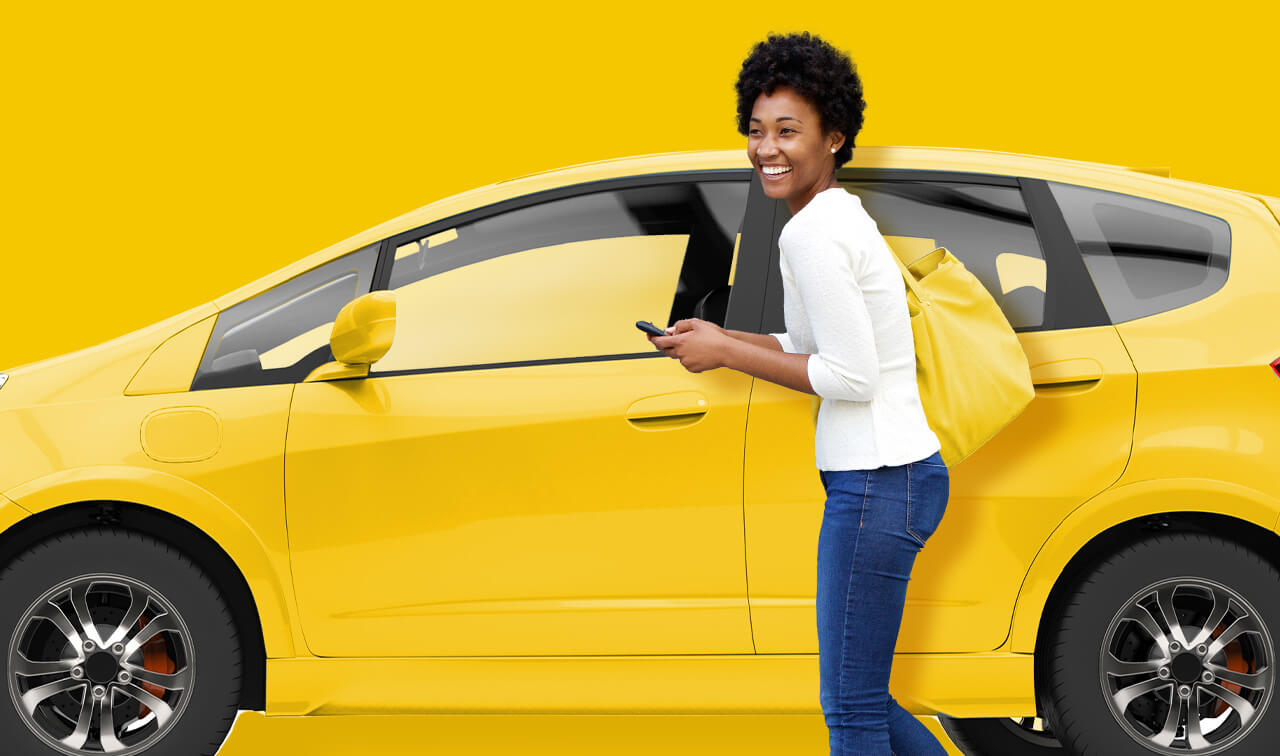 Woman gets into yellow car