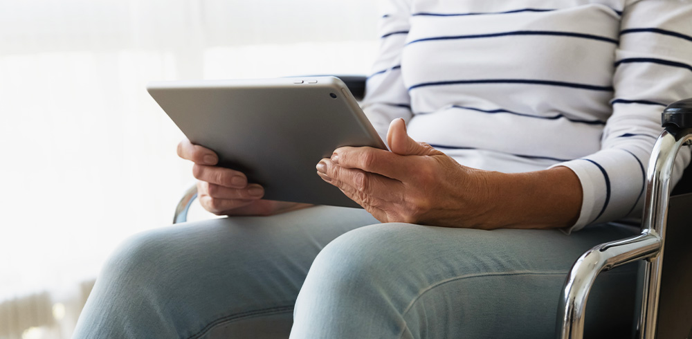 woman sitting down, with tablet in hands