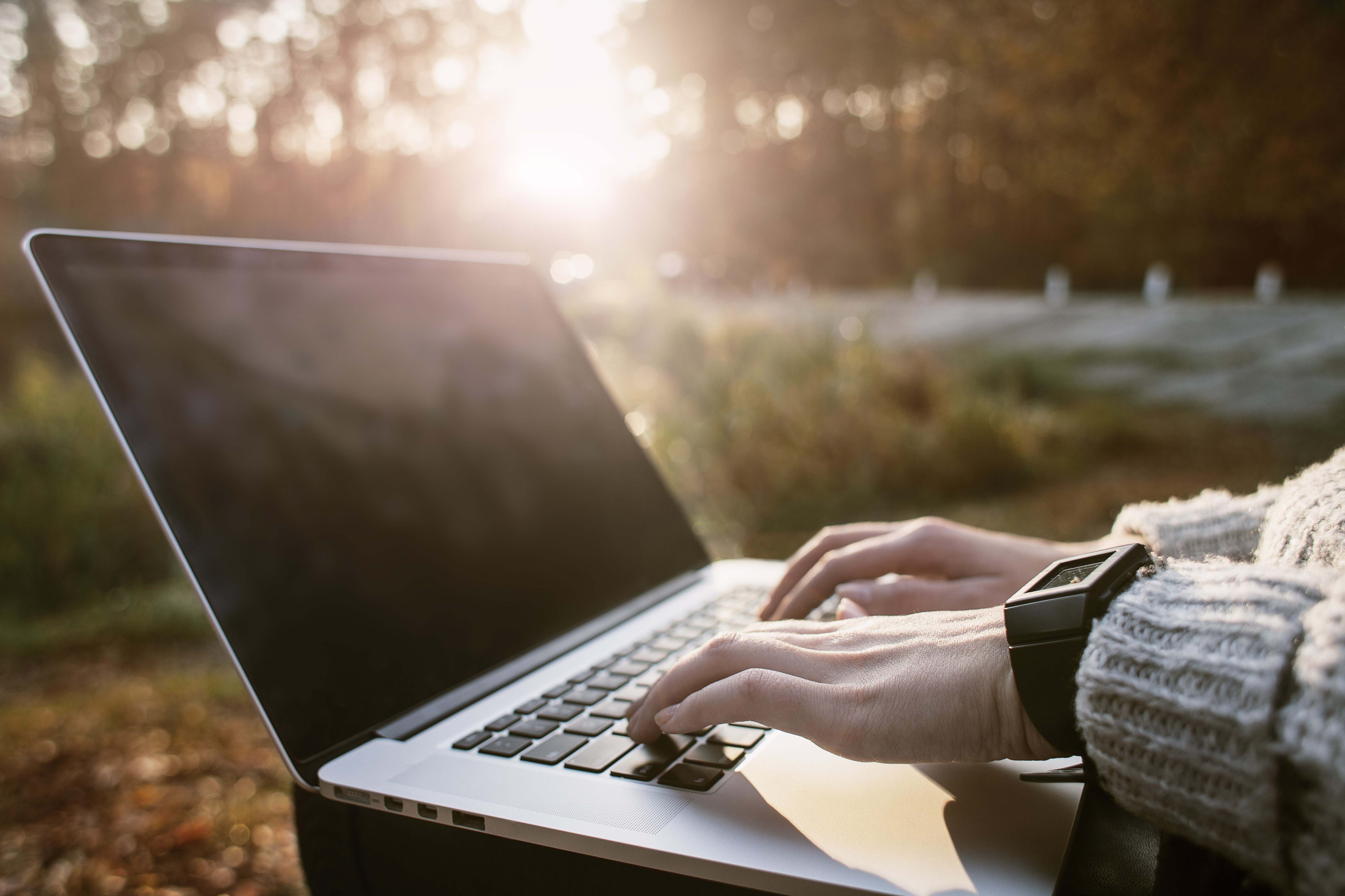 Working on a laptop outside