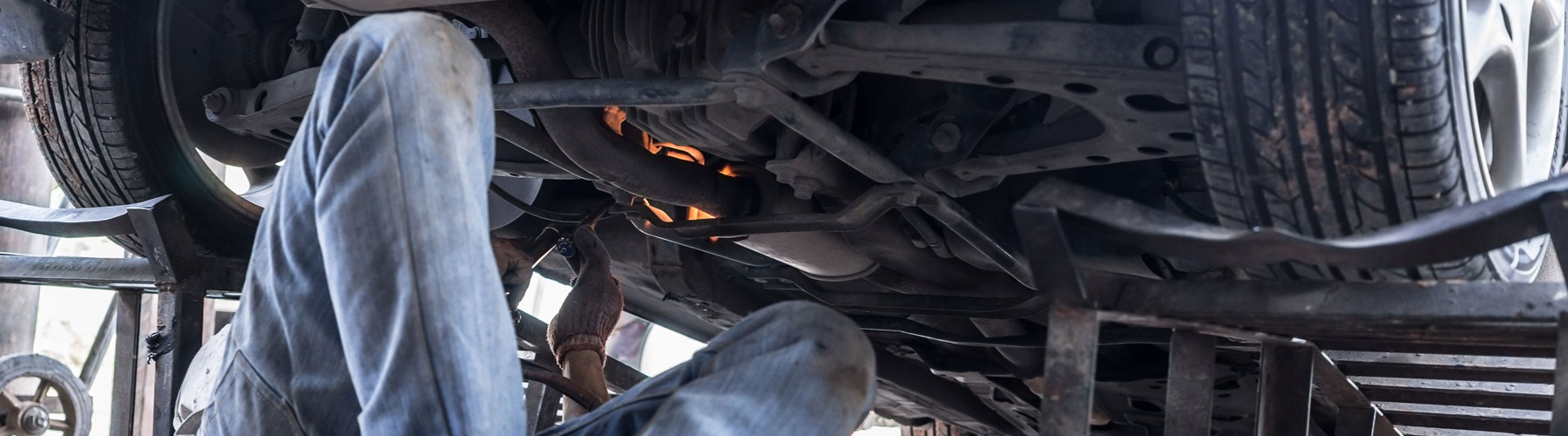 mechanic repairing car with green car parts
