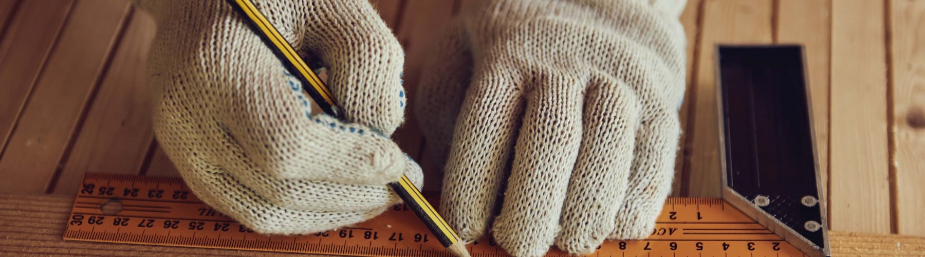 Carpenter using a ruler and pencil 