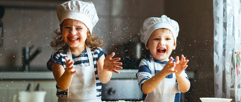 Happy kids having fun baking
