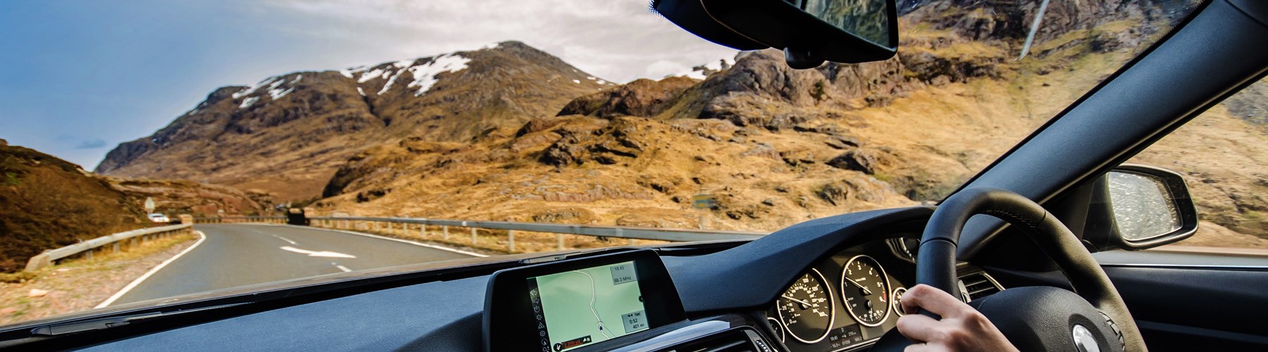 Man driving a car on a scenic road
