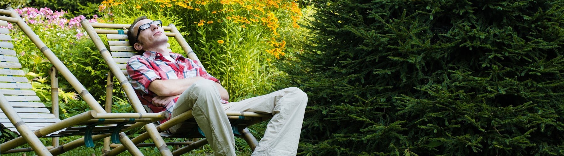 Man lounging in garden deckchair
