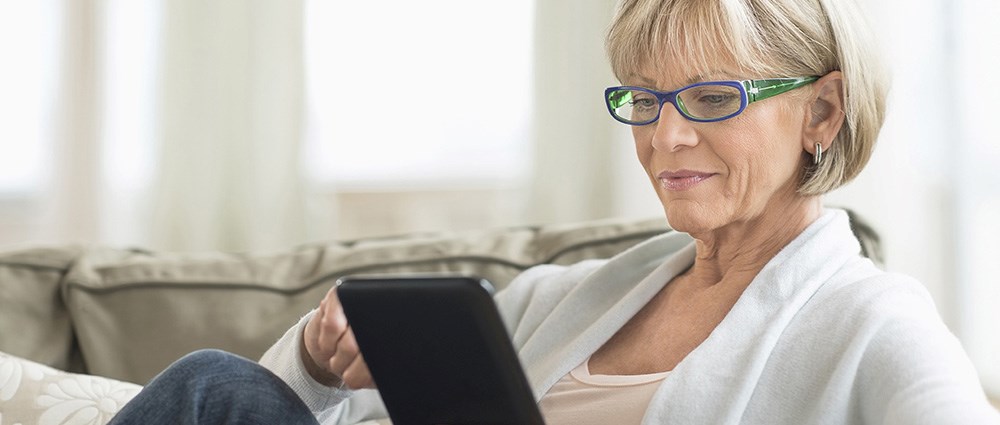 Woman playing on her ipad on the sofa