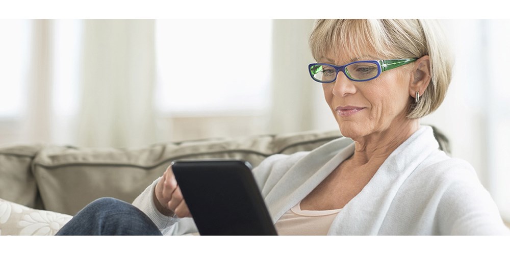 Woman playing on her ipad on the sofa