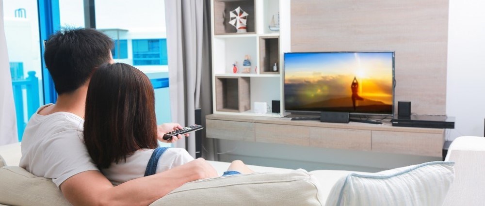 Couple watching TV in the living room