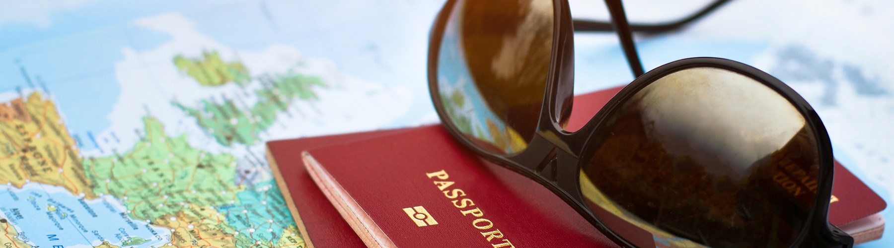Sunglasses and passport on map