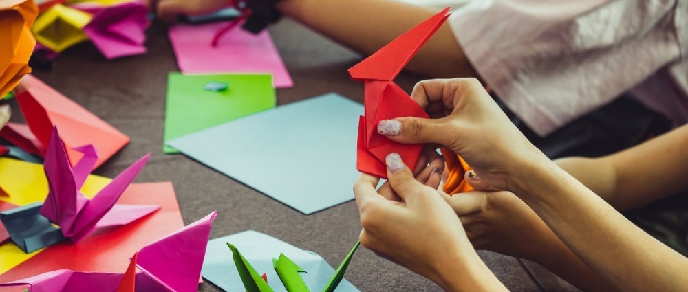 Woman's hands doing origami