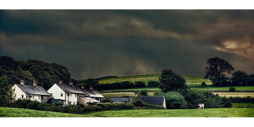 A stormy sky above houses in the countryside