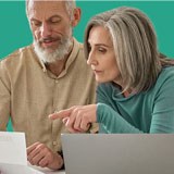 couple with laptop on green background