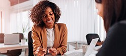2 women sat at desk